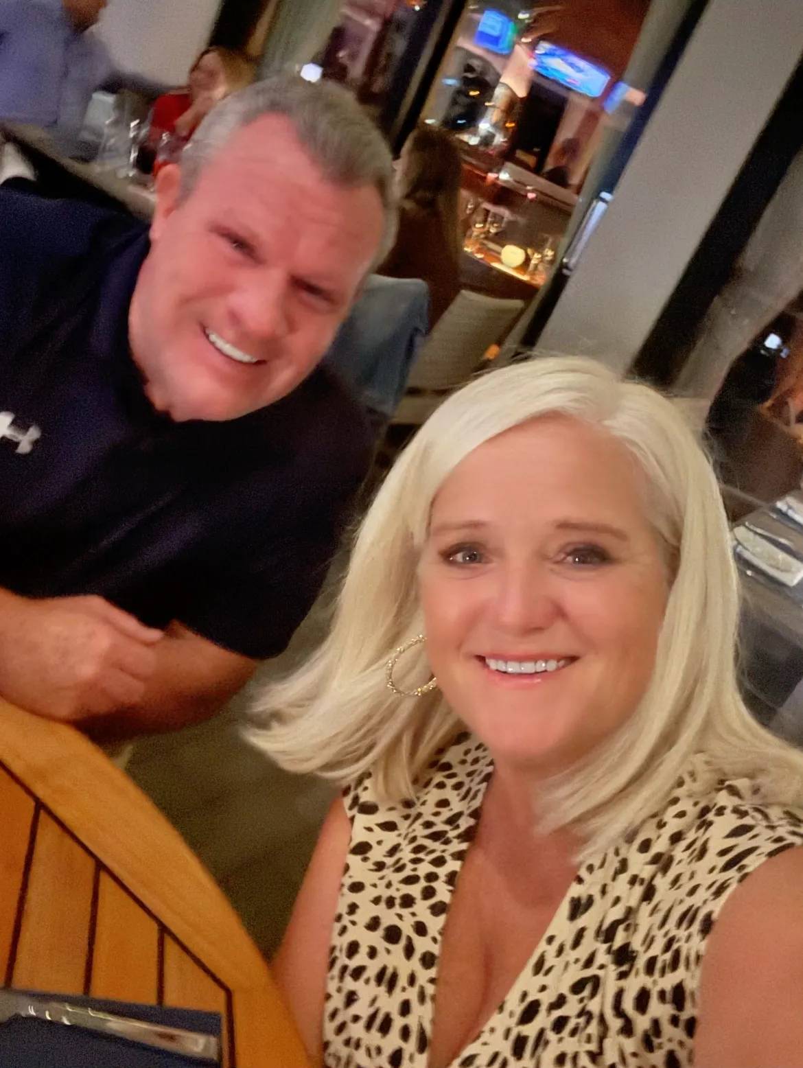 Smiling couple taking selfie at restaurant