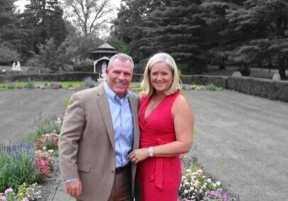 Couple posing in a garden setting.